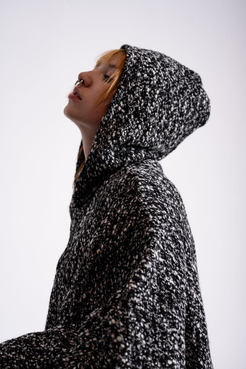 eigensinnig wien | Persephone | Extravagantes und weites Cape mit Kapuze aus Wolle in schwarz/weiß