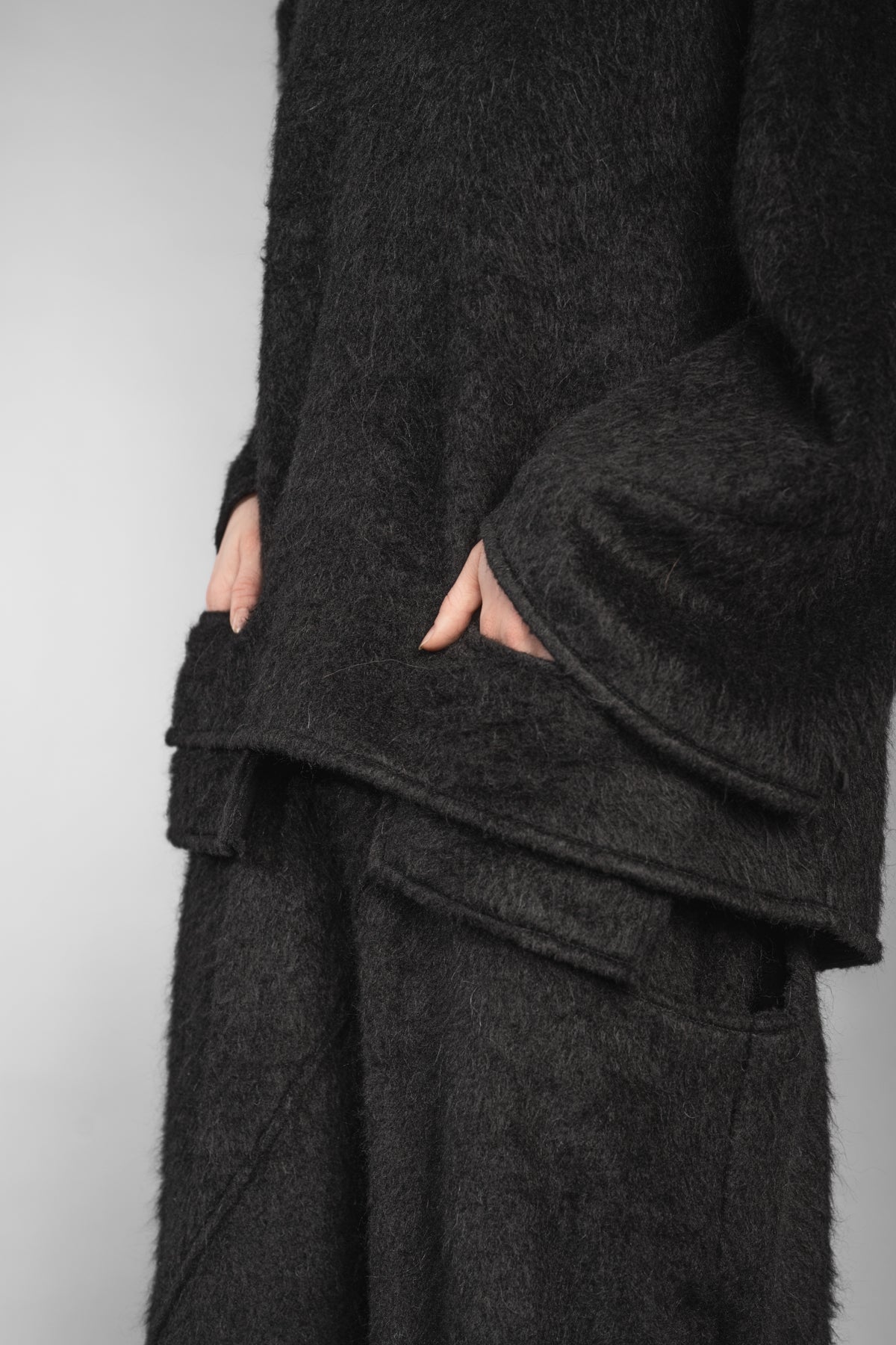 eigensinnig wien | Richier | Asymmetrischer schwarzer Flauschpullover für Damen mit Taschen