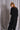 Forme d'Expression | DM129 Concaved Hem Knit Dress | Weites Strickkleid aus Schurwolle mit asymmetrischem Saum und wärmenden Kragen in schwarz